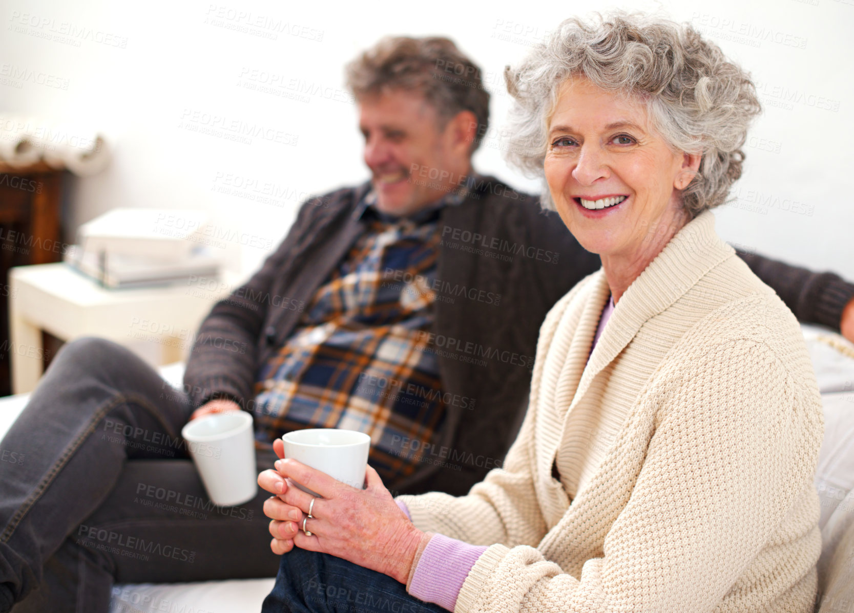 Buy stock photo Portrait of a senior couple relaxing in their living room with coffee