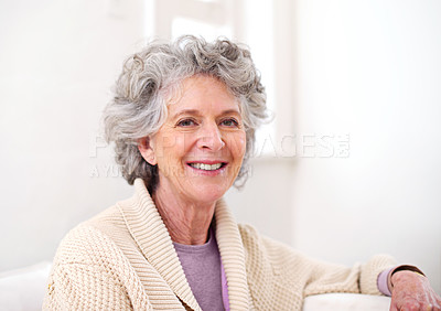 Buy stock photo Portrait of a happy senior woman sitting indoors