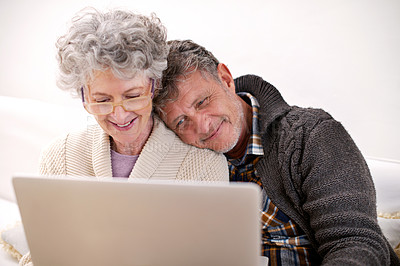 Buy stock photo Laptop, sofa and elderly couple with smile in living room for movie, bonding and love in retirement. Peace, relax and senior people with digital technology for happiness, streaming and enjoyment