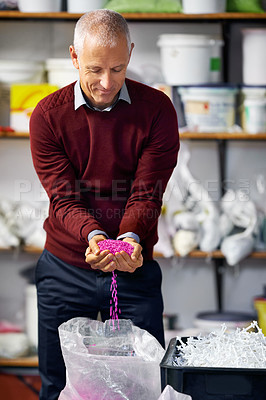 Buy stock photo Plastic factory, check or mature man with wax, pellet or granules for small business, startup or manufacturing. Warehouse, supply chain or worker show retail recycle product, industry or production