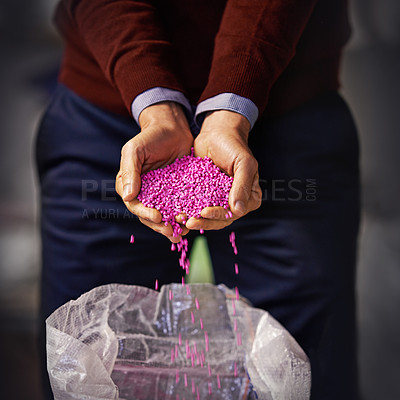 Buy stock photo Closeup shot of a man holding pink plastic granules