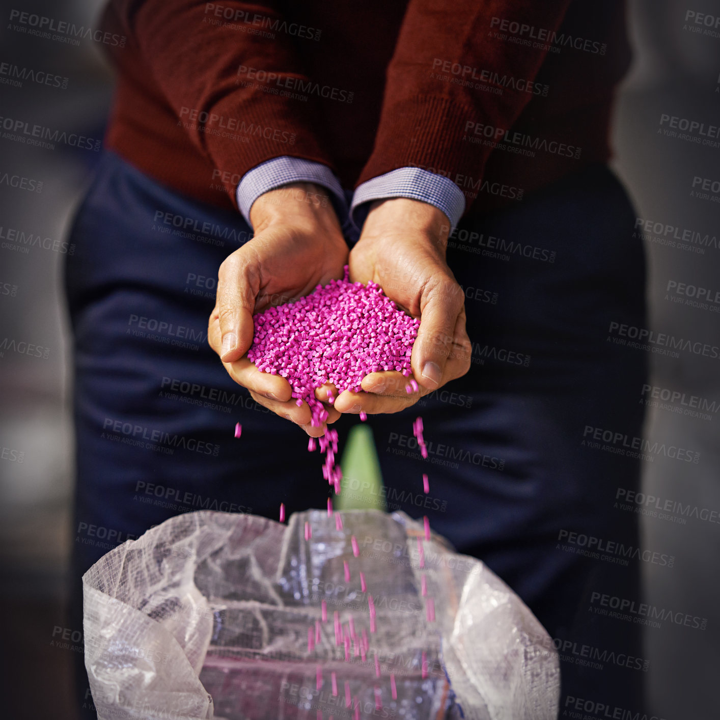 Buy stock photo Closeup shot of a man holding pink plastic granules