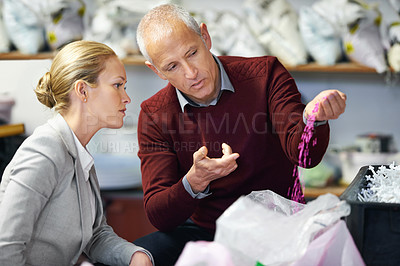 Buy stock photo Shot of two people in a plastic factory