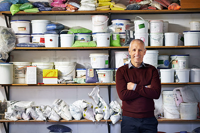 Buy stock photo Shot of a store owner standing in front of his merchandise