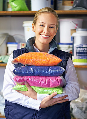 Buy stock photo Woman, polymer and plastic in factory, pellets and dye manufacturing and ecology in portrait at store. Person, color and employee for recycling at plant with storage, particles and bags in warehouse