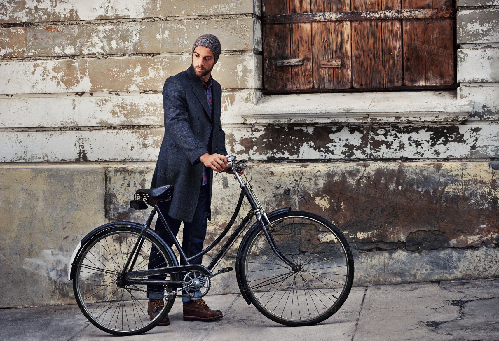 Buy stock photo Bicycle, fashion and man in city for travel on winter vacation, adventure or holiday with retro style. Vintage, stylish and male person on bike for cycling with beanie and coat for outfit in town.