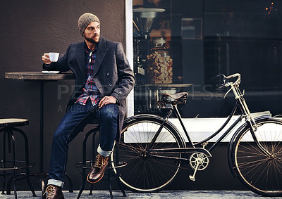 Buy stock photo Thinking, cafe and man with a coffee, bicycle and relax with thoughts, wonder and eco friendly transport. Male person, biker and guy with tea, outdoor and travel with winter fashion and a cappuccino