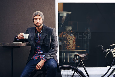 Buy stock photo Portrait, city and man drinking coffee with bicycle at cafe table for breakfast in the morning. Bike, tea cup and serious person with espresso, latte or beverage at restaurant with winter fashion