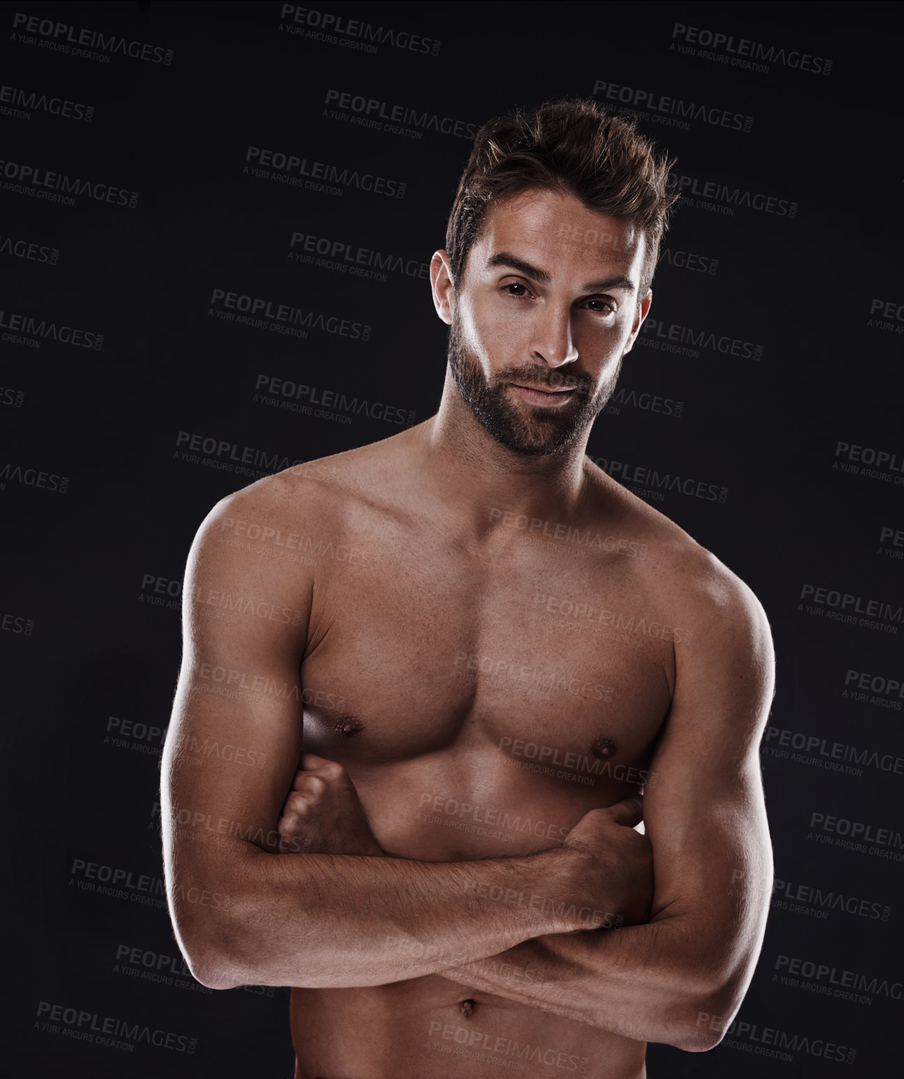 Buy stock photo Portrait, muscle and body of confident man in studio isolated on a black background for wellness, sexy or six pack. Model, face and topless person with arms crossed for health and strong abs in Spain