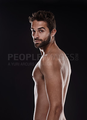 Buy stock photo Portrait of a handsome man standing shirtless against a black background