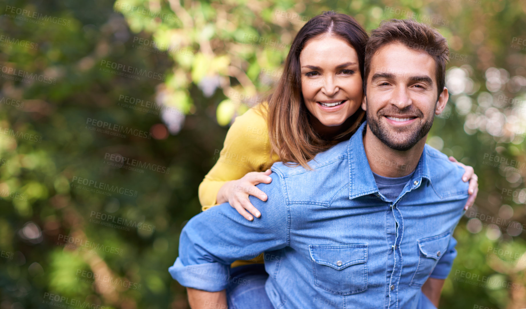 Buy stock photo Portrait, woman and man with piggyback in nature or park for bonding, dating and relationship with smile. Couple, love and romantic in backyard or outdoor with joy, excited and commitment in marriage