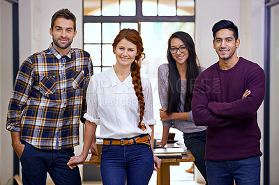 Buy stock photo Cropped shot of four young designers standing in their office