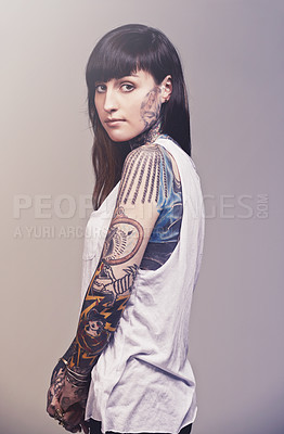 Buy stock photo Portrait, culture and woman with tattoos, confidence and punk rock on a grey studio background. Face, person and model with creativity or artistic with rebel and gothic with expression, casual or ink