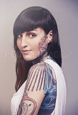 Buy stock photo Happy woman, portrait and tattoo with beauty or skin cosmetics on a gray studio background. Face of young female person, punk or body artist with smile for detail ink, design or cool tattooed art
