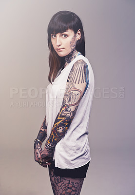 Buy stock photo Portrait, culture and woman with tattoos, rebel and punk rock on a grey studio background. Face, person and model with creativity or artistic with heavy metal or gothic with confidence, casual or ink