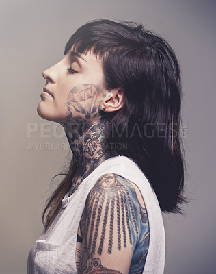 Buy stock photo Tattoo, profile and woman with culture, rebel and confident person on a grey studio background. Face, girl and unique with edgy clothes and gothic design with heavy metal and artistic with tradition