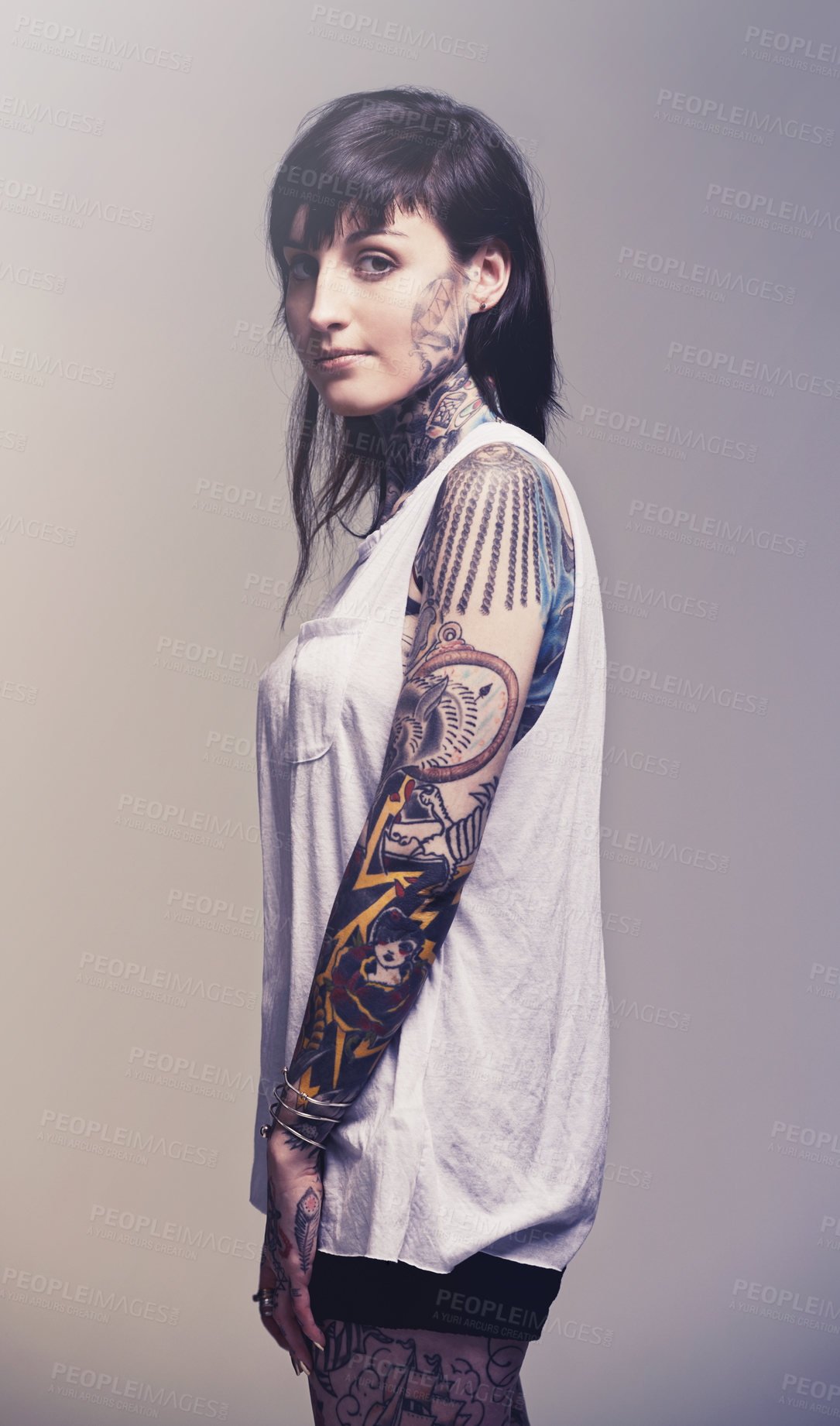 Buy stock photo Portrait, tattoo and culture with woman, rebel and punk rock on a grey studio background. Heavy metal, artistic and model with confidence and proud with edgy person and trendy with ink and creativity