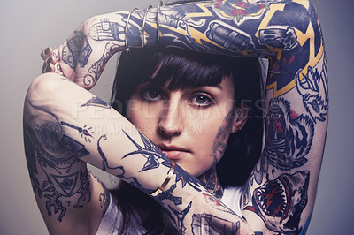Buy stock photo Tattoo, portrait and woman with culture, rebel and heavy metal on a grey studio background. Face, person and unique with edgy clothes and gothic design with confidence and artistic with tradition