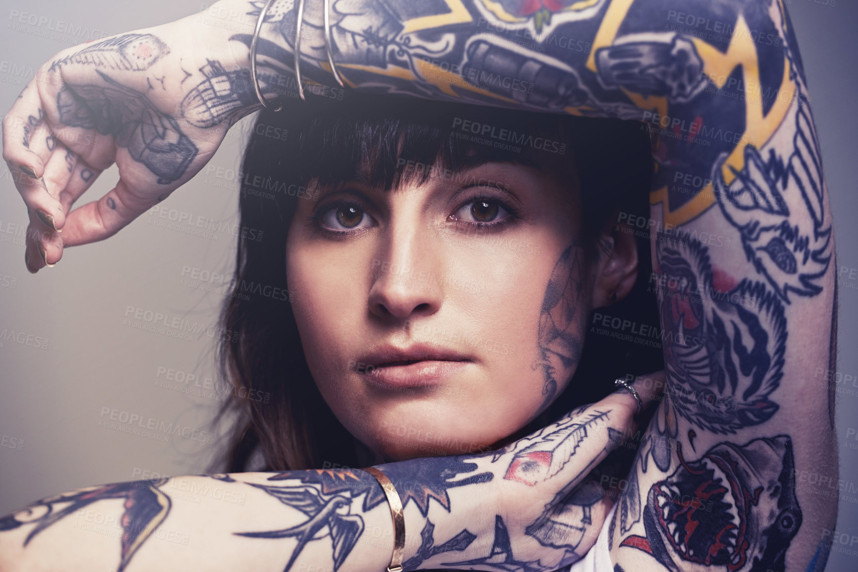 Buy stock photo A cropped studio portrait of a tattooed young woman