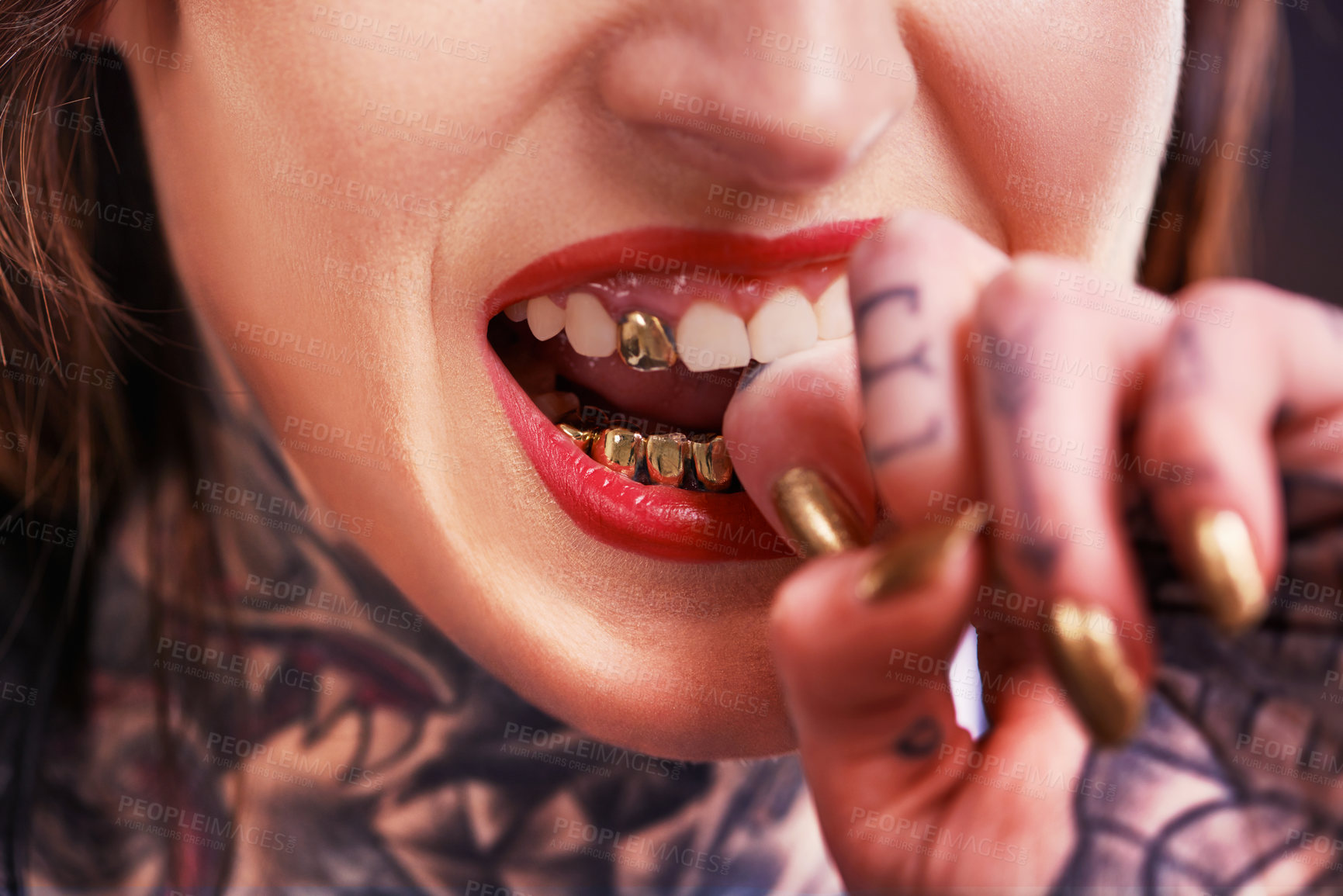 Buy stock photo Woman, bite and hand with tattoo and nails for grill on tooth and ink design for creative and unique. Art on skin for bold and cool for statement and funky for trend, gold and pattern with red lips 