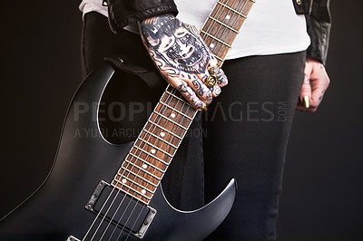 Buy stock photo Metal, woman and guitar on black background for punk culture or grunge, edgy and goth fashion with closeup. Rock star, hands and isolated in studio with instrument for band music with dark leather.