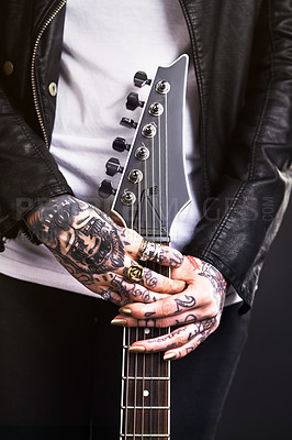 Buy stock photo Metal, woman and guitar on black background for rock culture or grunge, edgy and goth fashion with closeup. Punk star, hands and isolated in studio with instrument for band music with dark leather.