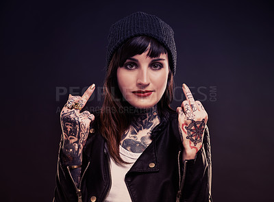 Buy stock photo Fashion, portrait woman with middle finger, tattoo or attitude in studio with gothic, style or artistic expression on black background. Rebel, face and emo model with hand, emoji or grunge aesthetic