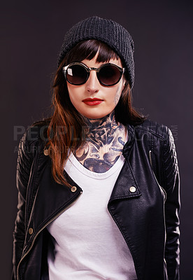 Buy stock photo Sunglasses, tattoo and woman in studio in a jacket on a black background for edgy style or aesthetic. Dark, leather and cool female punk model with ink for unique art, fashion or creative expression 