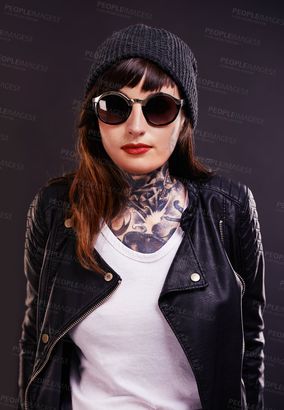 Buy stock photo Sunglasses, tattoo and woman in studio in a jacket on a black background for edgy style or aesthetic. Dark, leather and cool female punk model with ink for unique art, fashion or creative expression 