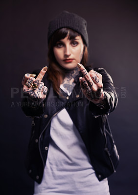 Buy stock photo Fashion, portrait or woman with middle finger, tattoo or attitude in studio with gothic, style or artistic expression on black background. Rebel, face or emo model with hand emoji or grunge aesthetic