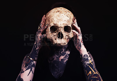 Buy stock photo Skull, art and woman with tattoo in studio for dark magic, horror or scary aesthetic with object. Creative nightmare, halloween culture and unique person in surreal bone portrait on black background