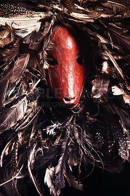 Buy stock photo Halloween, monster and festival skeleton with creative costume for unique dark horror animal skull in studio. Scary, traditional and surreal goat face mask with feathers for culture for sinister art