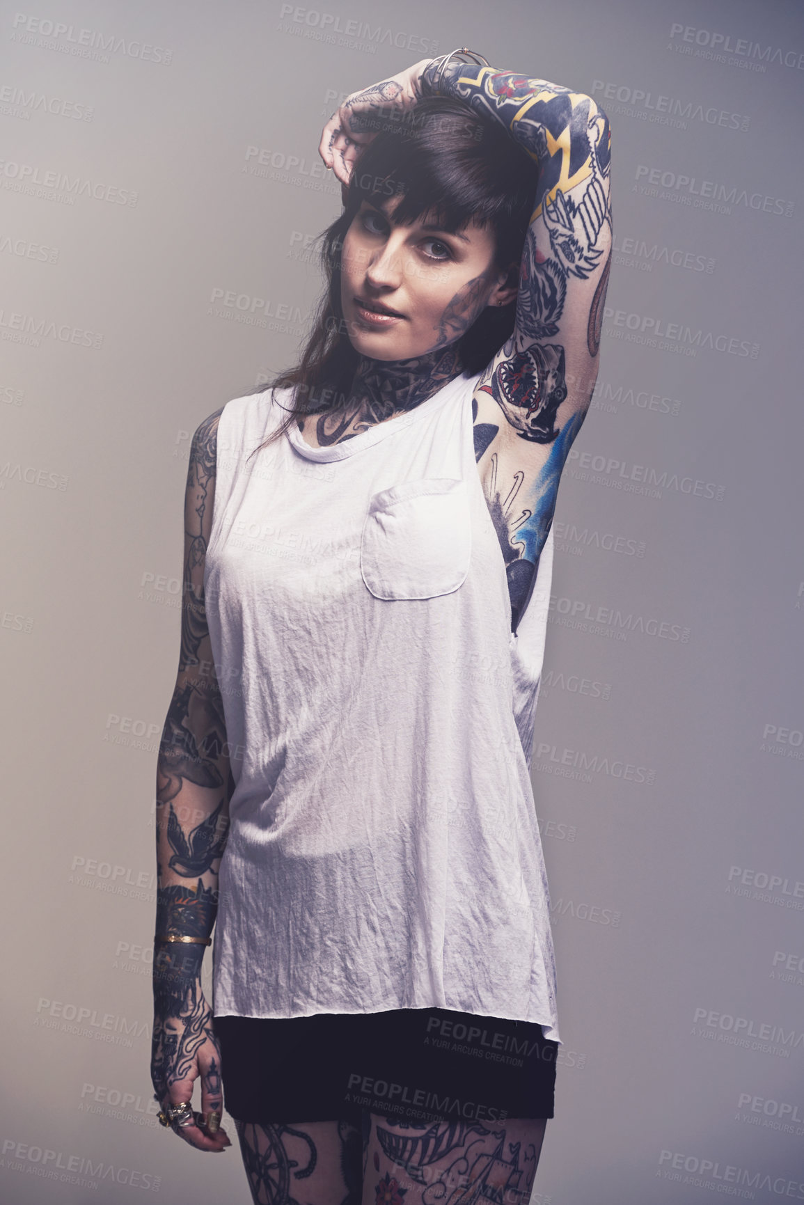 Buy stock photo A cropped studio portrait of a tattooed young woman