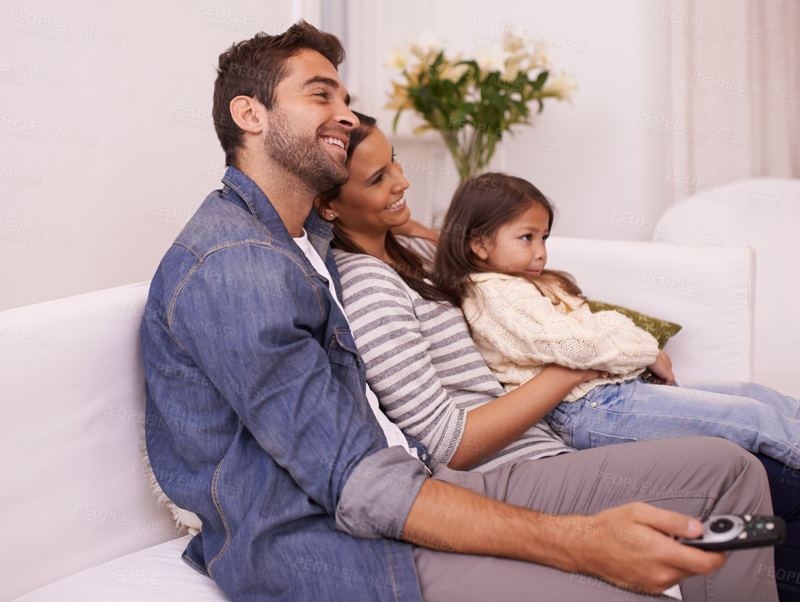 Buy stock photo Family, remote control or fun to relax on sofa, watching tv or cartoon as bonding together in home. Papa, mama or girl child on couch to enjoy show, series or broadcast in living room at weekend