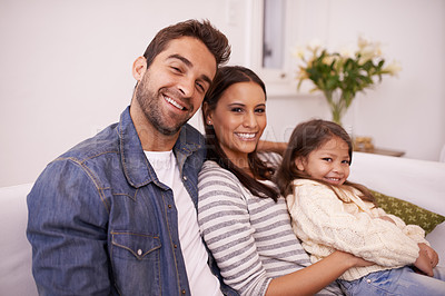 Buy stock photo Smile, portrait and family with love in living room for support, bonding and relaxing together. Happy, father and mother with daughter for weekend enjoyment, care and childhood development at home