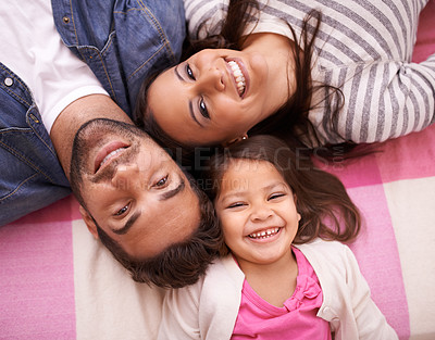 Buy stock photo Family, portrait and little child in bedroom for bonding, happiness and having fun in home. Love, top view and caring parents with young girl enjoying time together, smiling and laughing in apartment