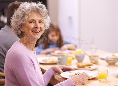Buy stock photo Cropped portrait of a senior woman enjoying breakfast with her family