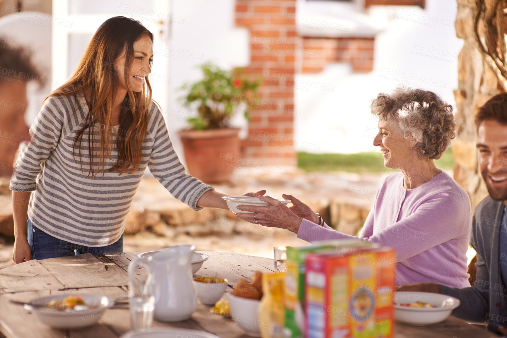 Buy stock photo Family, eating and happy in garden for breakfast with serve, hosting and bonding for nutrition or wellness. Senior, women and relax together in backyard or patio in morning with healthy meal or food 