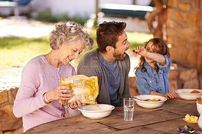 Buy stock photo Happy family, food and breakfast in backyard of home for nutrition, bonding and eating together with porridge. Father, grandma and child with healthy diet, meal or feed at dining table in the morning
