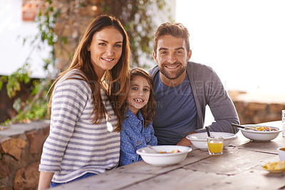 Buy stock photo Happy family, portrait and breakfast with juice, smile and garden for vacation, nutrition and bonding. Father, mother and daughter at table in morning for summer holiday, together and healthy food. 