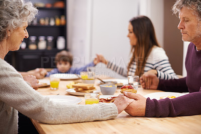 Buy stock photo Religion, big family and prayer for food, breakfast and table in kitchen with mom, son and senior parents. Home, women and man worship for eating, bread and juice for diet, healthy and gratitude