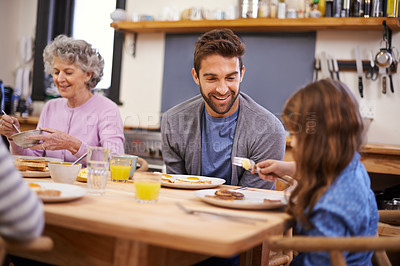 Buy stock photo Love, breakfast and family in a kitchen with pancakes, eating or bonding at a table together. Food, diet and girl with father, grandmother and waffle for brunch, nutrition or communication at home