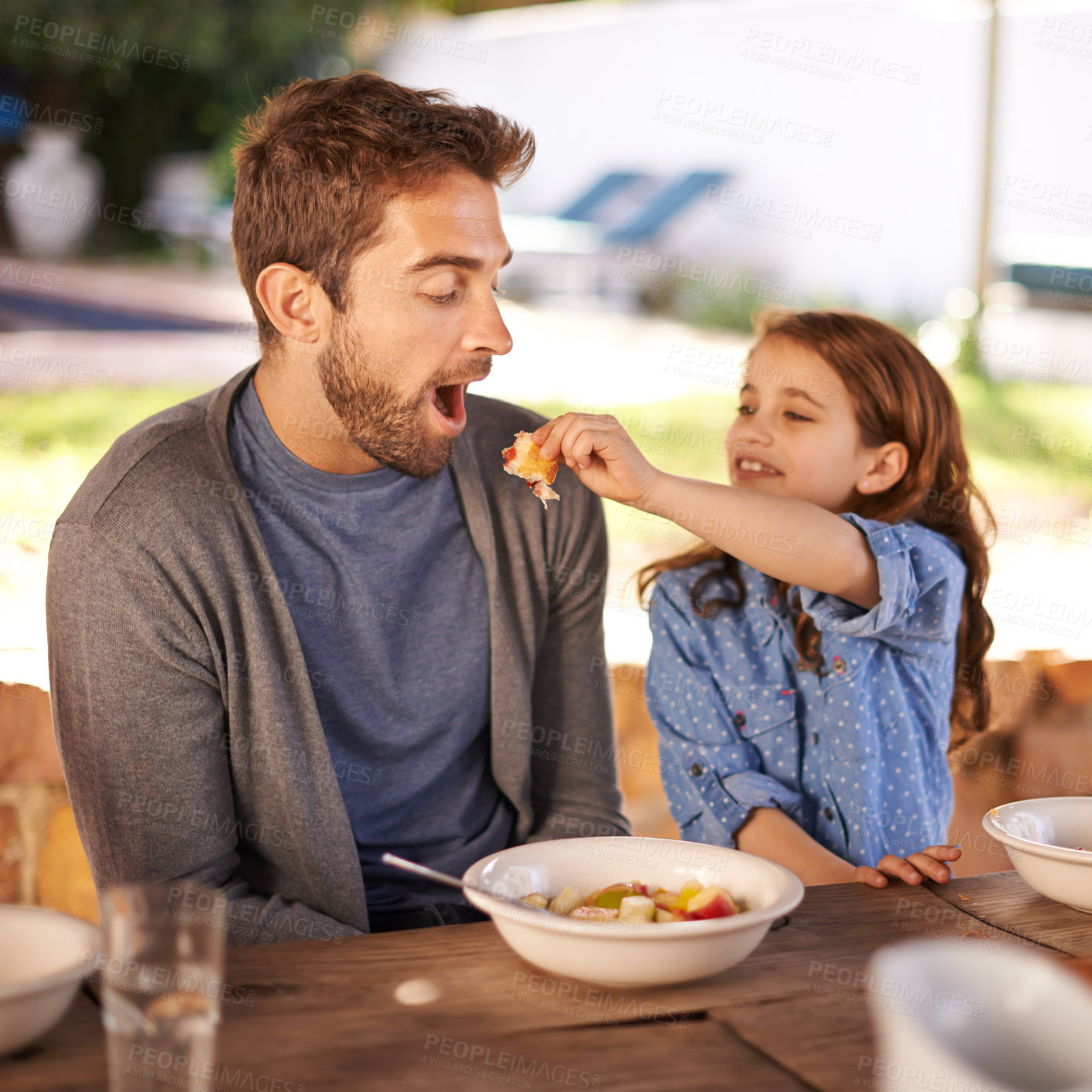 Buy stock photo Shot of a little girl eating breakfast with her dad