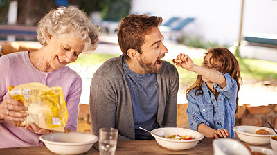 Buy stock photo Happy family, eating and breakfast in garden of home for nutrition, bonding and relax together with porridge. Father, grandma and child with healthy diet, meal and feed at dining table in the morning