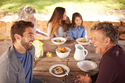 Buy stock photo Cropped shot of a family having a meal together outside