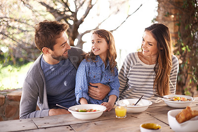 Buy stock photo Cropped shot of a family having a meal together outside