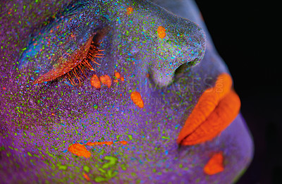 Buy stock photo Neon paint, beauty and woman face closeup with dark background and creative cosmetics. Glow makeup, fantasy and psychedelic cosmetic of a female model with unique and creativity with art in studio 