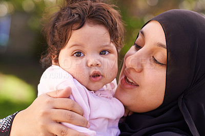 Buy stock photo Muslim woman, mother and baby with hug for love, care and bonding during Eid in Cape Town, South Africa. Female person, child and family together outdoor in nature, garden and backyard with affection