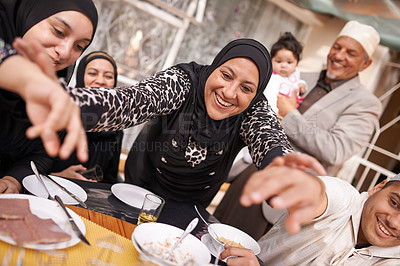 Buy stock photo Muslim family, Eid and smile by table with food for celebration, conversation and eating together. Islamic people, culture and religious holiday with lunch for nutrition, discussion and special event