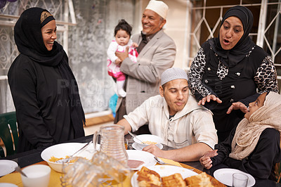 Buy stock photo Muslim family, Eid and discussion by table with food for celebration, conversation and eating together. Islamic people, culture and religious holiday with lunch for nutrition, love and special event